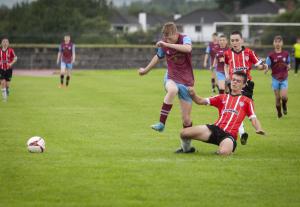 Tummery’s Peter Colton is thwarted by this late tackle from a Derry defender.