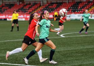 Sion Swifts Ladies forward Zoe McGlynn holds off Derry City's Hayley McDonald.