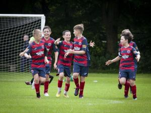 Clooney YC players celebrate their opening score.