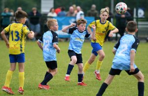 Magherafelt Sky Blues Colts player Conor Mooney heads the ball towards goal.