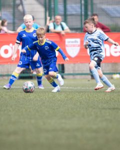 A-young-player-takes-control-of-the-ball-thursday-game-24-July-in-Leafair-Between-Eglinton-Eagles-and-Greencastle-by-Roisin-McFadden