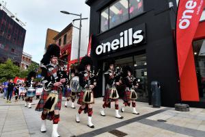 The Lislaird Pipe Band leading the parade past the O'Neill's Superstore.